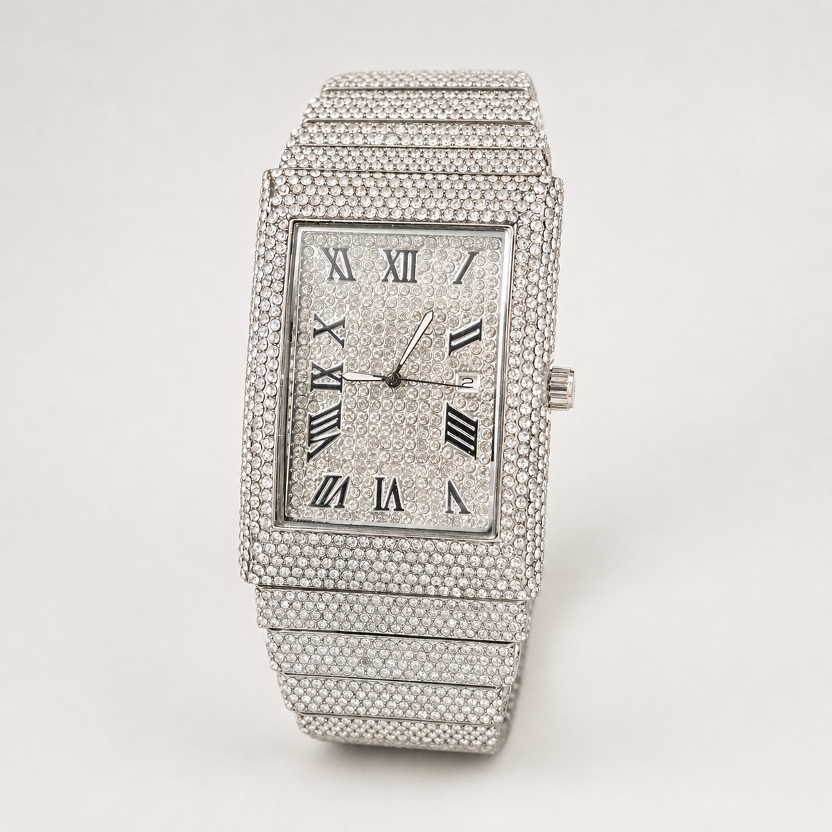 Angled view of silver-tone rectangular watch with Roman numeral dial and date window