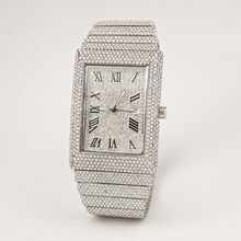 Angled view of silver-tone rectangular watch with Roman numeral dial and date window