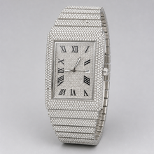 Three-quarter view of silver-tone rectangular watch with Roman numeral dial and date window