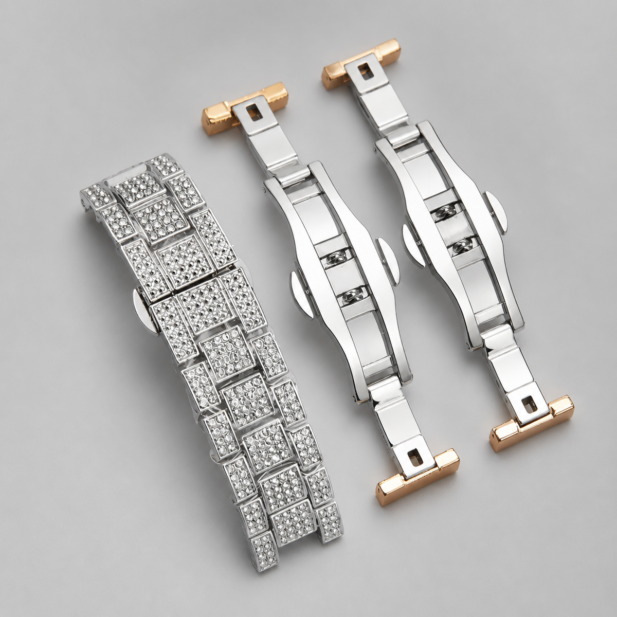 Silver-tone and rose-gold crystal-set bracelet and clasp components, close-up