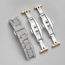 Silver-tone and rose-gold crystal-set bracelet and clasp components, close-up