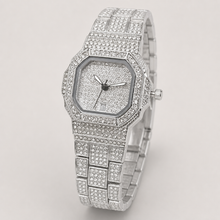Silver-tone women’s octagonal quartz watch with a crystal-set grid bracelet, angled view