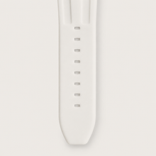 White silicone watch strap with adjustment holes, close-up