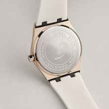 Rear view of the white-strap octagonal watch showing the case back