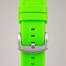 Lime-green silicone watch strap with silver buckle and keepers, close-up