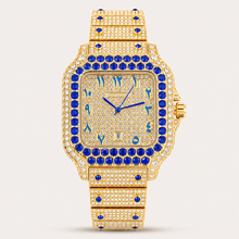 Gold-tone square watch with blue border accents, front view