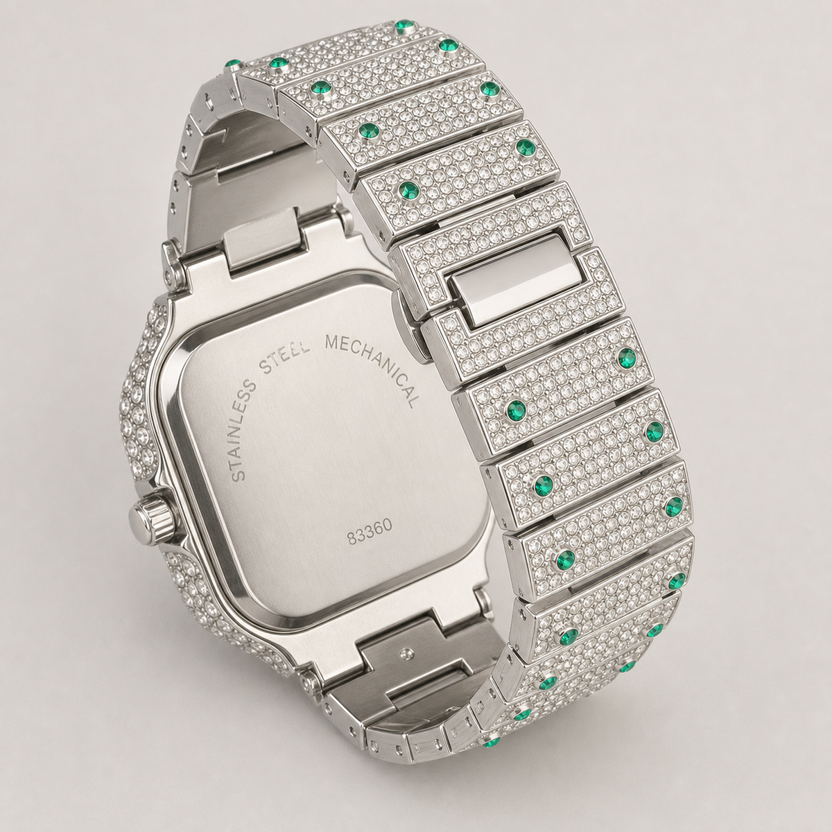 Rear view of a silver-tone square watch with green border accents and open bracelet