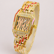 Gold women’s square quartz watch with a pink striped dial and multicolour jewel-link bracelet, angled view