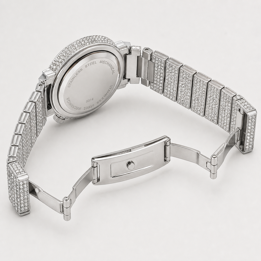 Silver-tone crystal-set watch with open deployant clasp and caseback engraved “STAINLESS STEEL MECHANICAL”