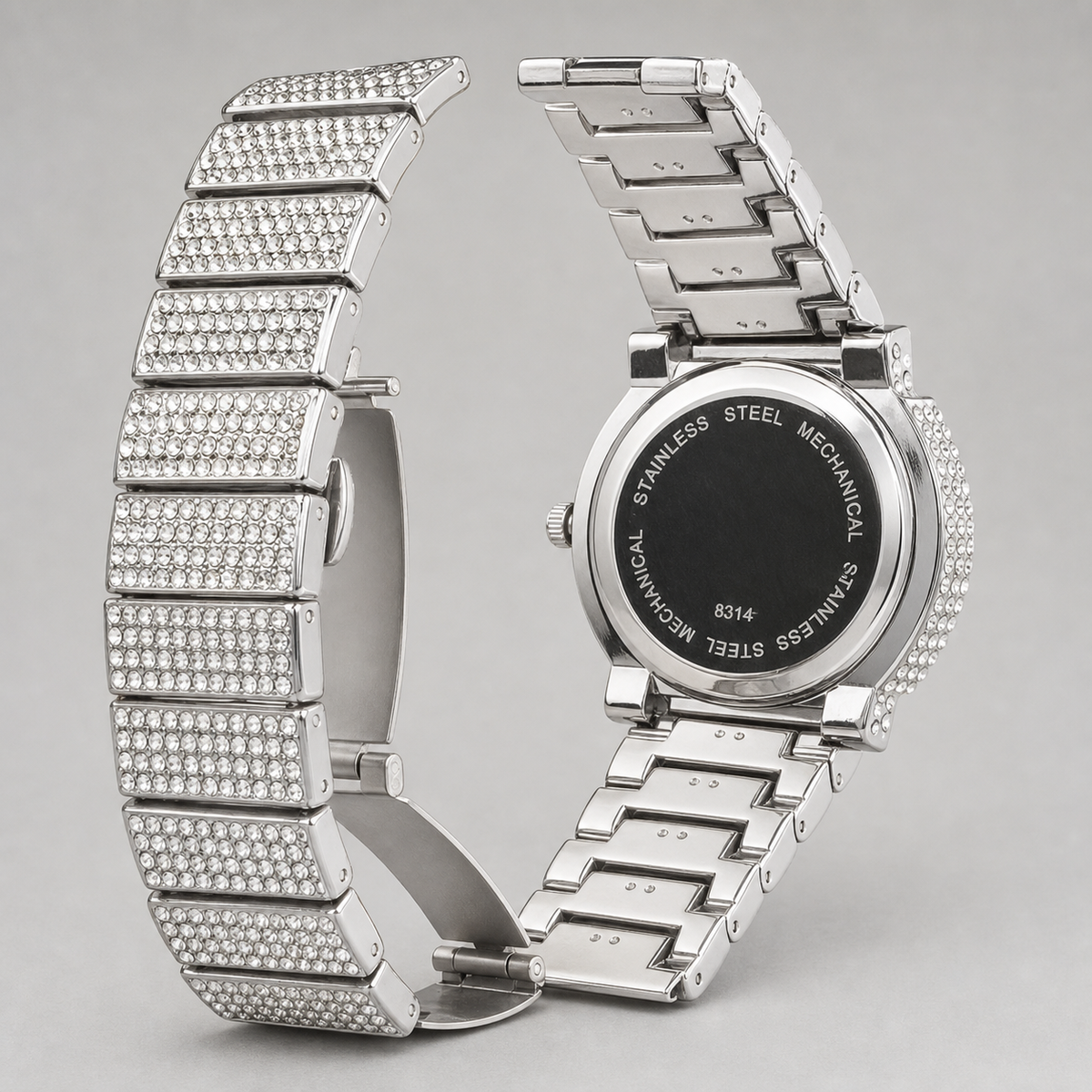 Silver-tone crystal-set watch with open deployant clasp and “8314” caseback engraving
