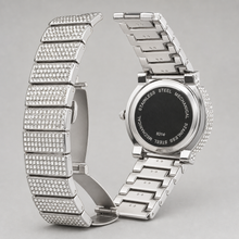 Silver-tone crystal-set watch with open deployant clasp and “8314” caseback engraving