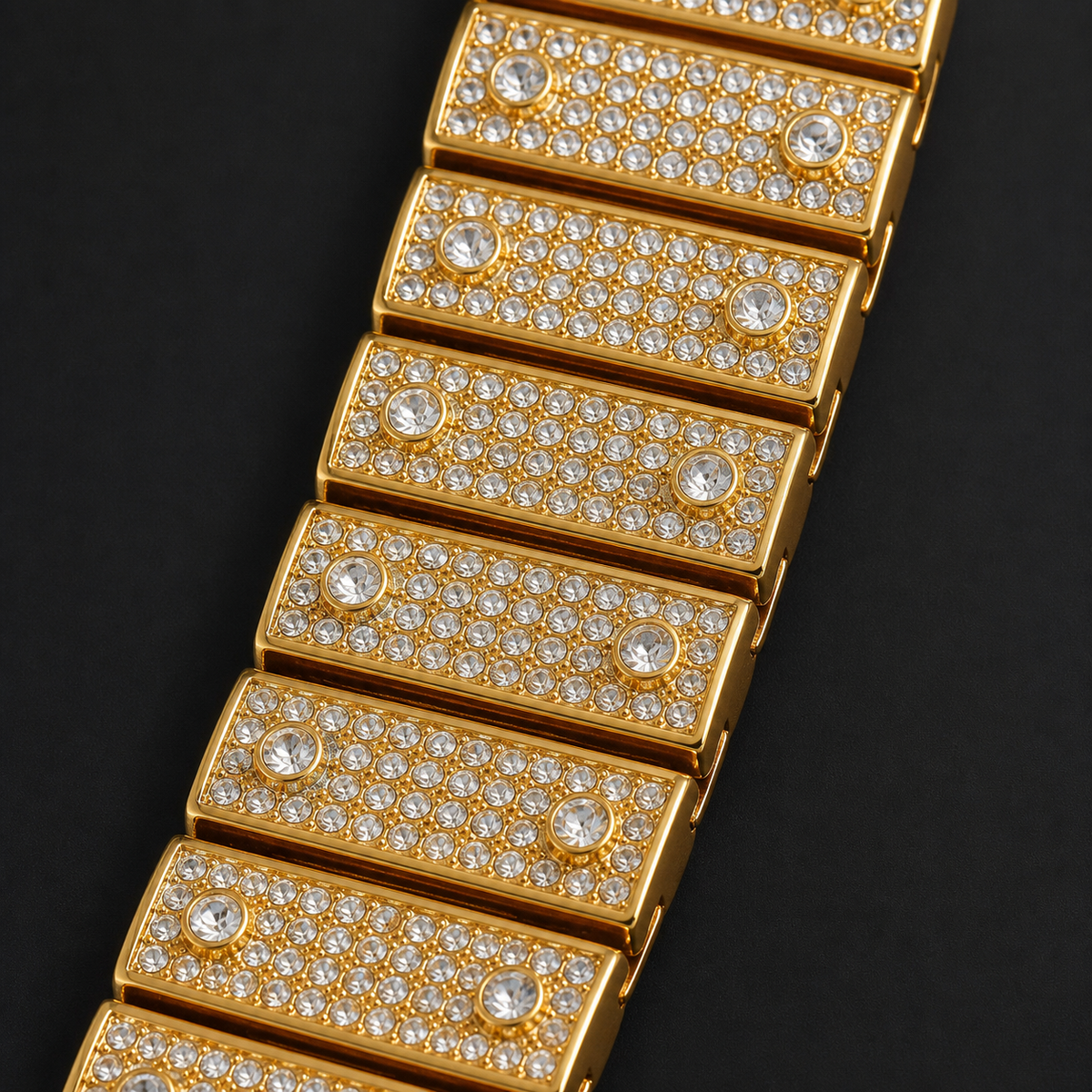 Gold-tone crystal-set watch bracelet with pavé links, detail view